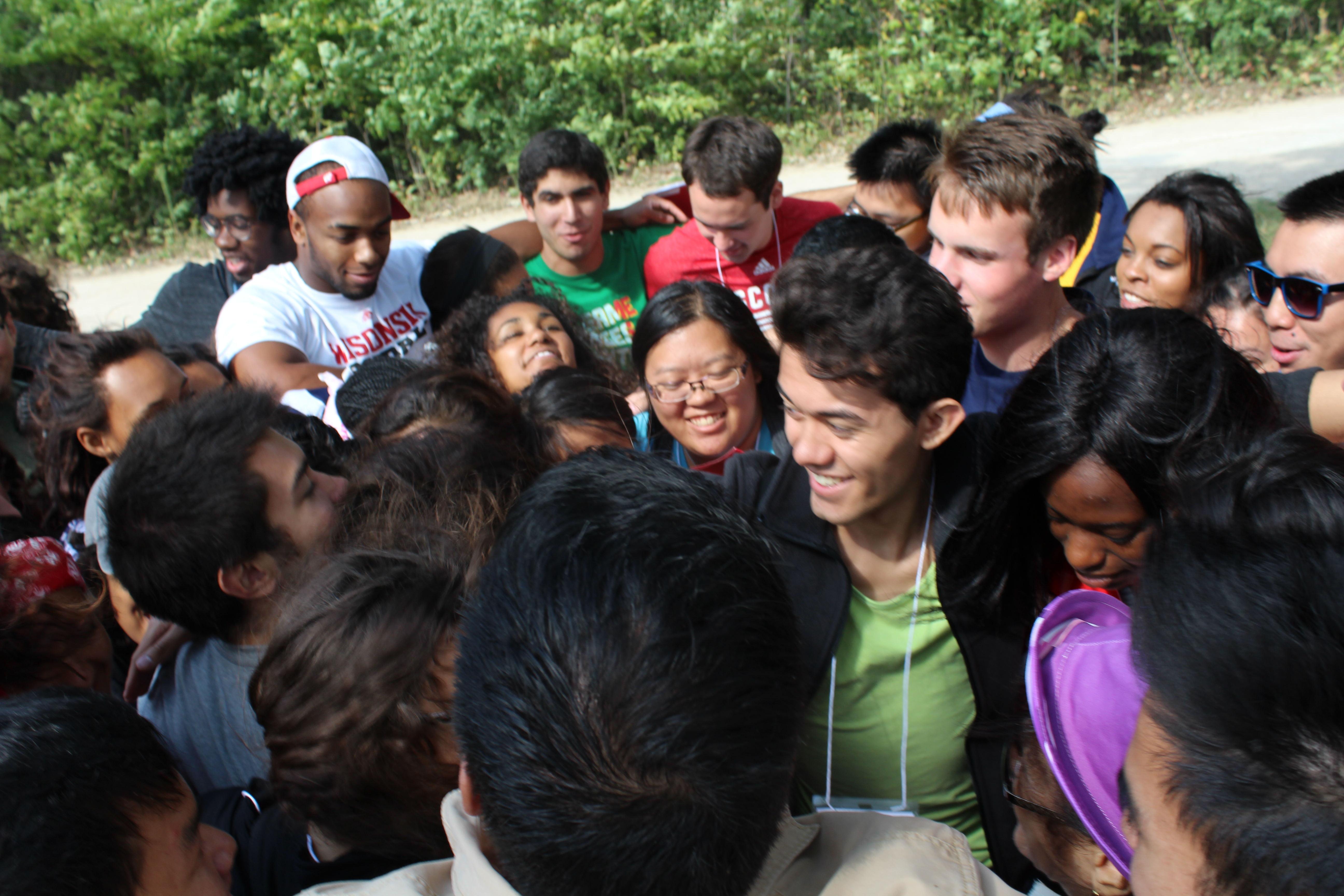 A group of scholars crowd together.