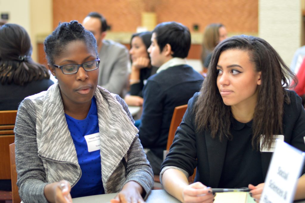 Olivia Alston (right) listens to her PKS Big Sibling Sangay Sirleaf (left) at the PKS Networking Dinner. Photo credit: Cameron Smith