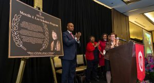 People clapping in honor of Mercile J Lee on a sign